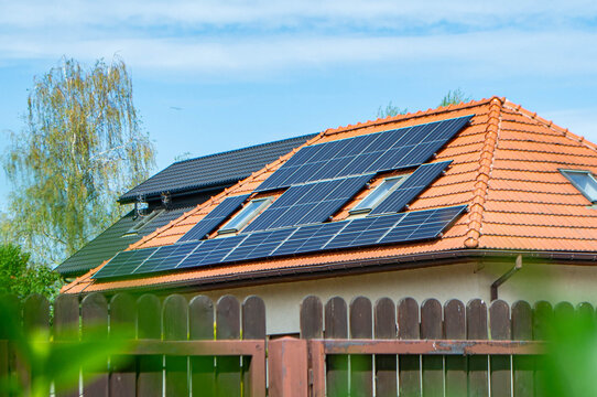 House roof with photovoltaic modules. Historic farm house with modern solar panels on roof and wall High quality photo