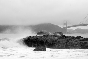 Baker beach in the fall with tide coming in and golden gate bridge