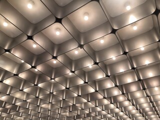 Interiors of illuminated ceiling lights forming a pattern.Beautiful ceiling with LED lighting.