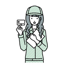 立って書類とカードを手に持つ作業員の女性