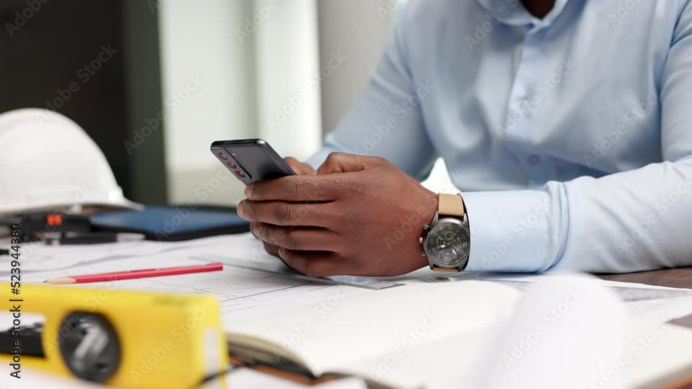 Poster closeup of the hands of an engineer or architect on a phone typing, reading email or on social media