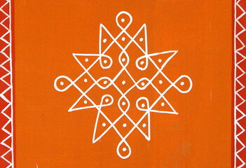 Indian Hindu traditional rangoli drawing on the wall of rural house
