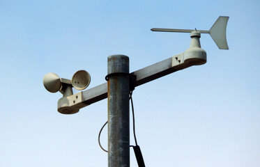 view of a windpane and anemometer against blue sky