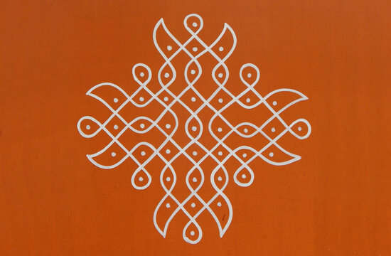 Indian Hindu traditional rangoli drawing on the wall of rural house