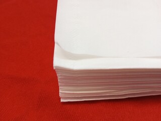 a pile of white tissue paper on a red background