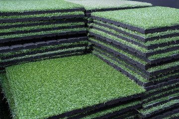 Green artificial grass carpet mat with underlay layer asphalt. Lawn turf Grass decoration. Gardening material, Landscape design.