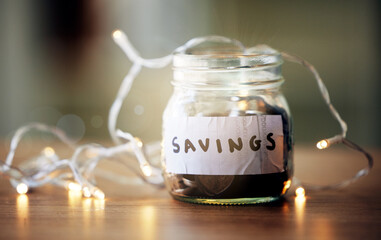 Finance, investment and future planning with a collection of many coins, money in a jar on a table. Retirement fund or growth profit, budget, saving for financial security. Banking on a tax returns