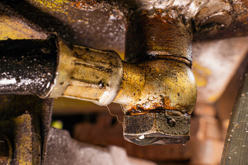 Fuel line angle connector with leaking fuel drop. Fuel leak near the tank due to corrosion...