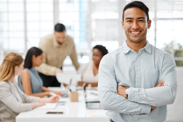 Smiling, happy and proud young business man with arms crossed showing great leadership to his team in an office. Portrait of a confident entrepreneur satisfied with new opportunity in a startup