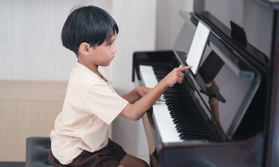 Inside the music room, children sit and play music in the room.Practice of learning musical...