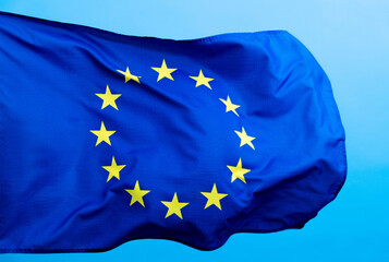European Union Flag waving on blue background