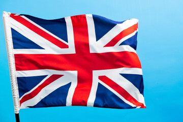 Fototapeta premium British flag waving on blue background