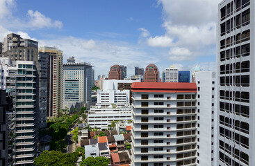 Beautiful Singapore skyline panorama with blue skies and puffy clouds. 
