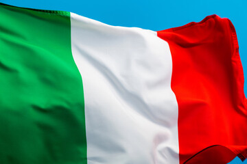 Italian flag waving on blue background