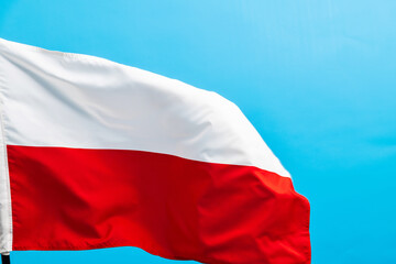 Poland flag waving on blue background