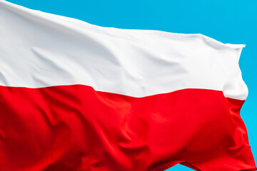 Poland flag waving on blue background