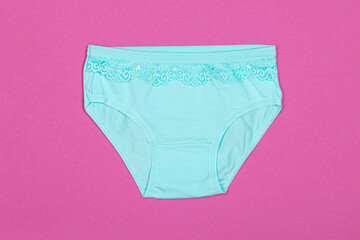 Clothes for children in the form of panties on a pink background. Clothes for children from soft...