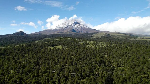 drone shot of the majesty of the popocatepetl volcano during a fumarole exhalation in mexico city during morning