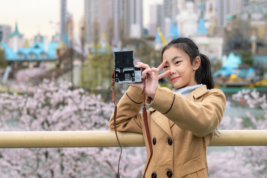 Asian woman traveler take selfie at view point in Seoul city, South Korea in winter season with cherry blossom background