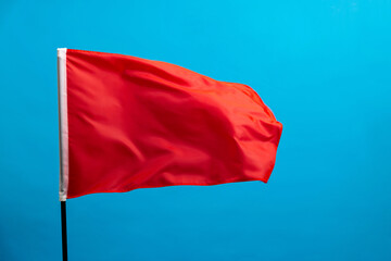 Red flag waving on blue background