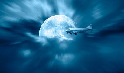 Old metallic propeller airplane in the sky with full Moon 
