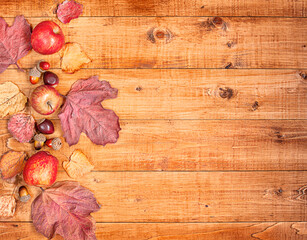 Fototapeta na wymiar wooden table with composition of autumn leaves, acorns, apples with copy space
