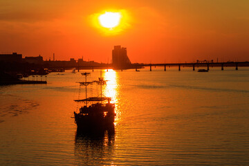 Fototapeta na wymiar Tourist ship sailing on the Dnieper river at sunset in Dnipro, Ukraine