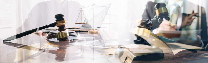 Justice and law concept. Gavel on sounding block in hand's Male judge at a courtroom, working with document law books, report the case on table in modern office.