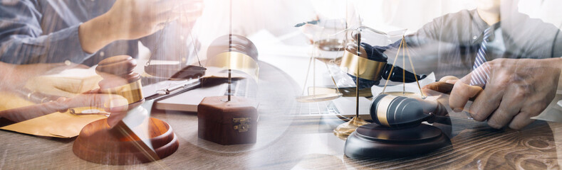 Justice and law concept. Gavel on sounding block in hand's Male judge at a courtroom, working with document law books, report the case on table in modern office.