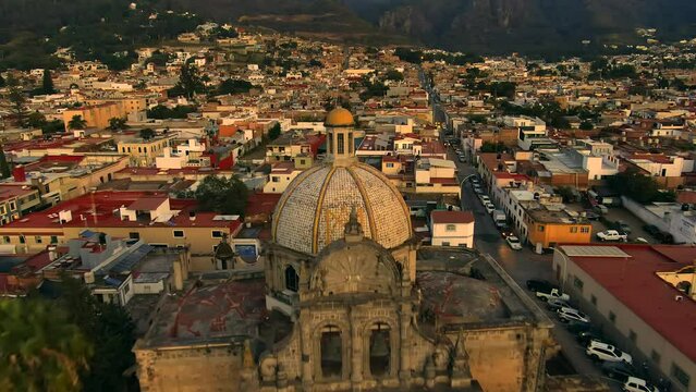 Aerial View Of Parroquia del Sagrario During Sunset In Ciudad Guzman, Jalisco, Mexico - drone pullback