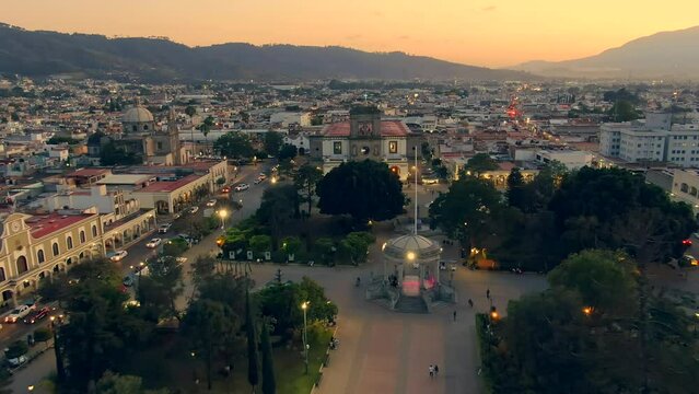 Aerial View Over Municipal Ciudad Guzman Garden During Sunset In Jalisco, Mexico - drone pullback
