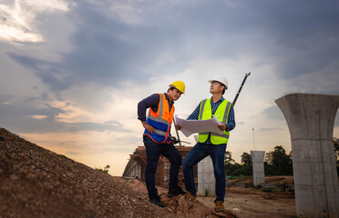 Engineer and foreman worker checking project at building site, Engineer and builders in hardhats...