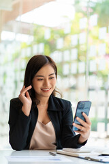 Asian business woman working in finance with laptop and smartphone, accounting concept.