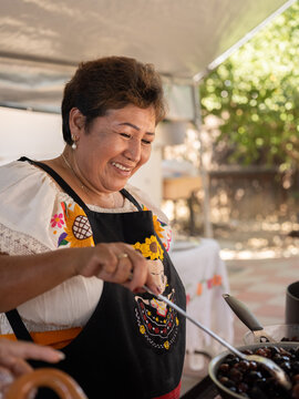 Portrait of an Indigenous mother cooking 