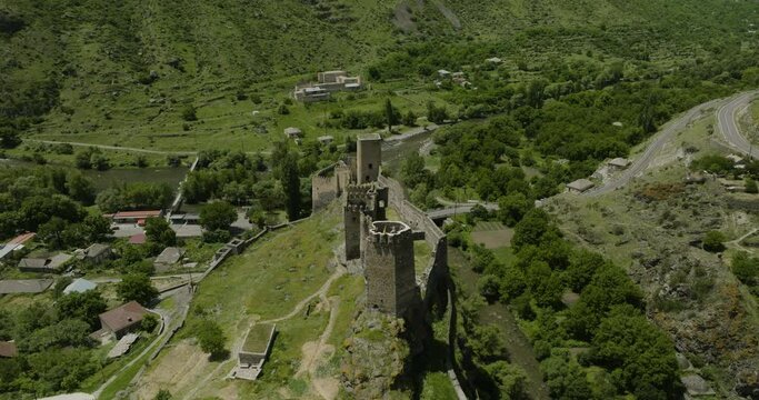 Old Khertvisi Fortress On High Rocky Hill In The Narrow Canyon At The Confluence Of Mtkvari And Paravani Rivers In Georgia. aerial drone flyby
