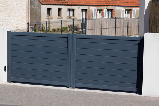modern sliding large grey steel gray gate closed aluminum home portal of suburb house