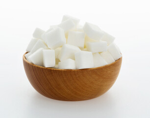 Sugar cubes in a bowl on white background