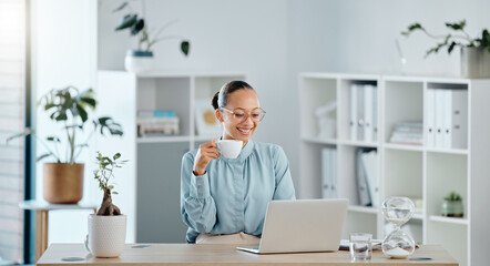 Small business owner, startup manager or entrepreneur working on a laptop in her office and drinking tea. Young business woman reading, typing or sending an email and feeling motivated and ambitious