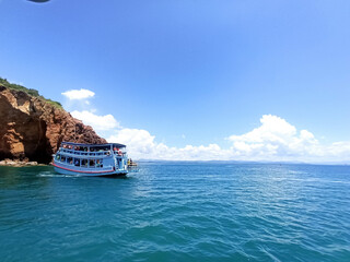 Khao Talu Cave, Prachuap Khiri Khan Province, Thailand with a big boat taking tourists to snorkel Beautiful under the sea, bright sky, emerald green sea It is a landmark for tourists to stay in Asia.