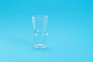 Empty glass on blue background