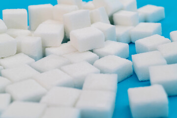 Fototapeta premium Sugar cubes on blue background
