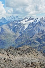 Mountain landscape of the Caucasian ridge with snow lying on them.