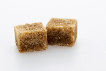 Brown sugar cubes on white background