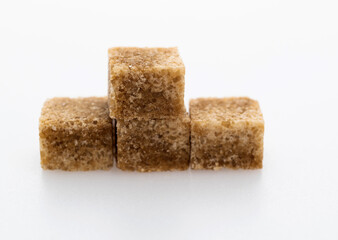 Brown sugar cubes on white background
