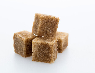 Brown sugar cubes on white background