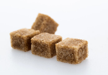 Brown sugar cubes on white background
