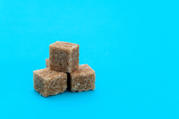 Brown sugar cubes on white background