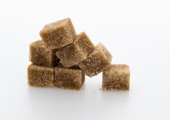 pile of brown sugar cube on white background