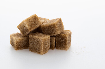 pile of brown sugar cube on white background