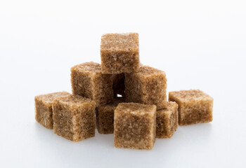pile of brown sugar cube on white background